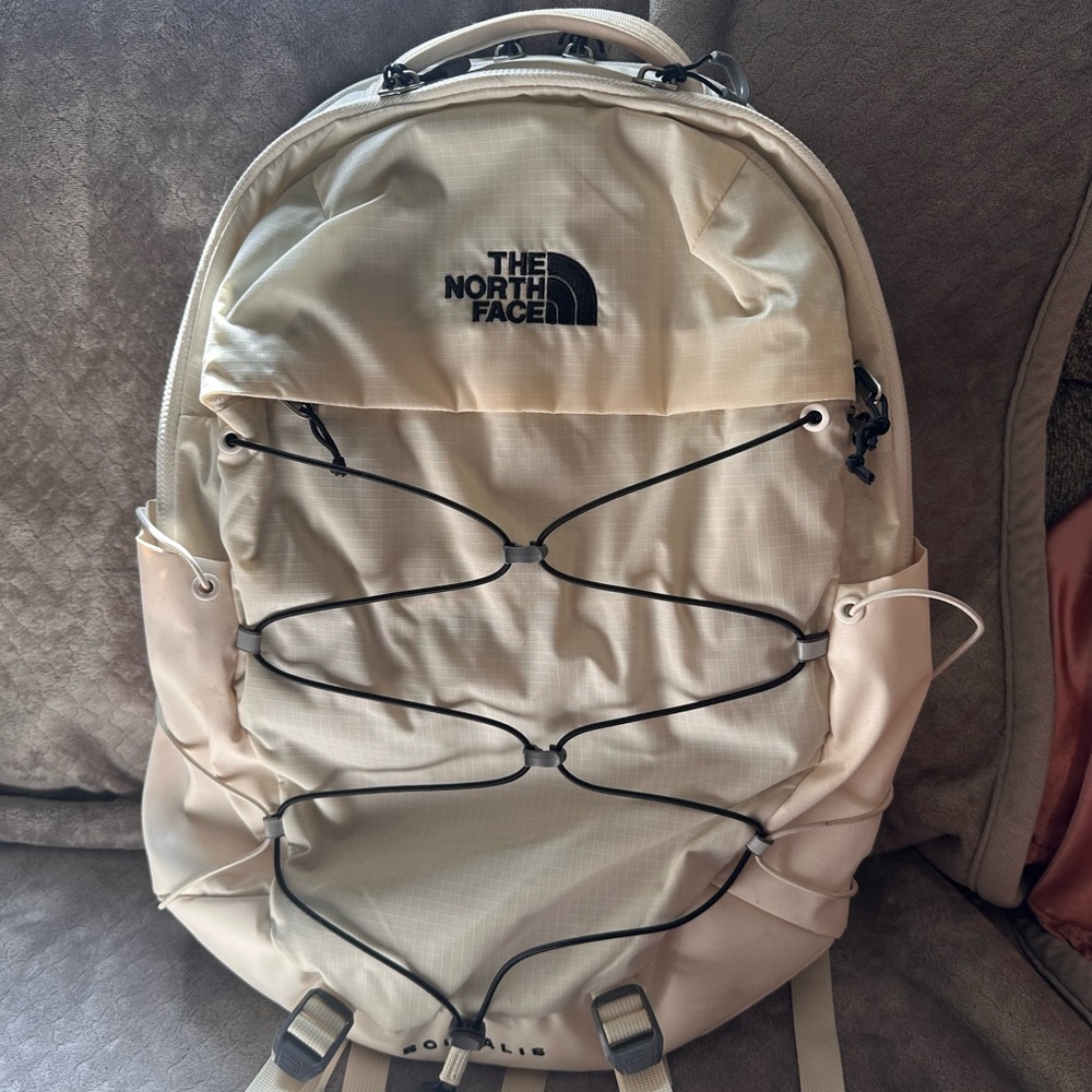 The North Face Cream Backpack with Bungee Cord Design